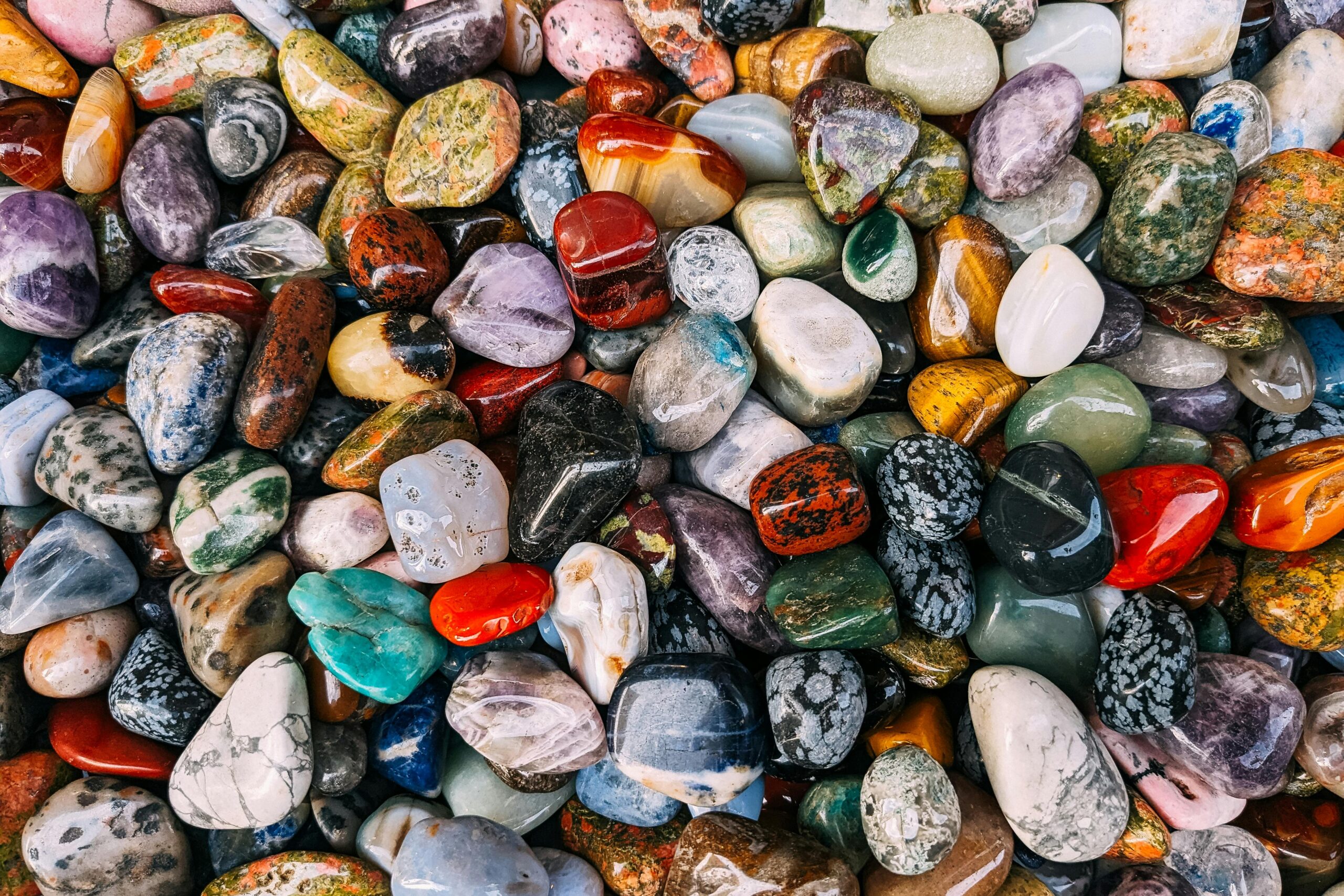 Vibrant assortment of polished gemstones displaying rich colors and textures.